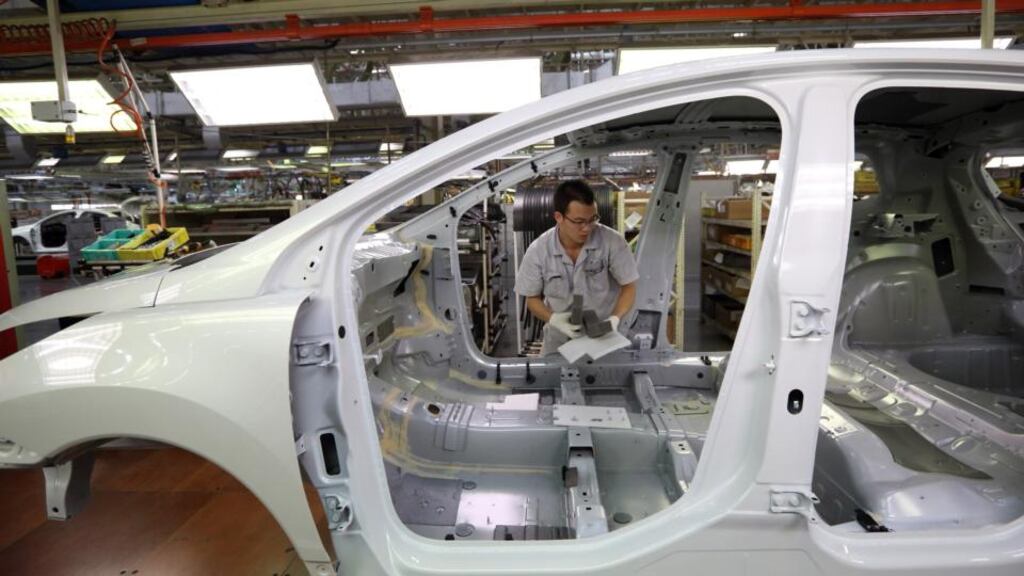 A worker assembles a vehicle on the production line at a plant operated by Dongfeng Peugeot-Citroen Automobile, the joint venture between Dongfeng Motor Corp. and PSA Peugeot Citroen, in Wuhan, China. PSA Peugeot Citroen has agreed to sell a stake in Peugeot to Dongfeng and the French government. Photograph: Tomohiro Ohsumi/Bloomberg