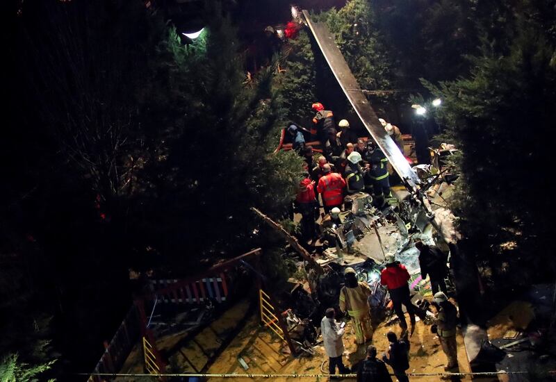 Fire fighters and police inspect the site of the crash Photograph: Umit Bektas/Reuters