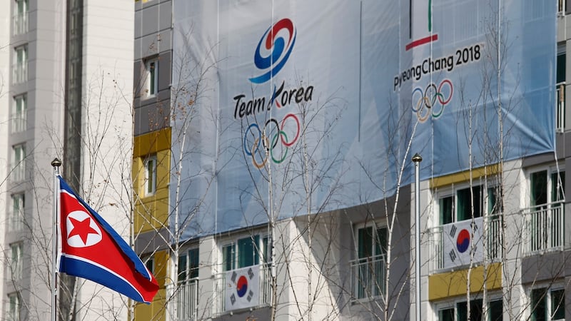 The North Korean flag is raised during the Team Welcome Ceremonies.