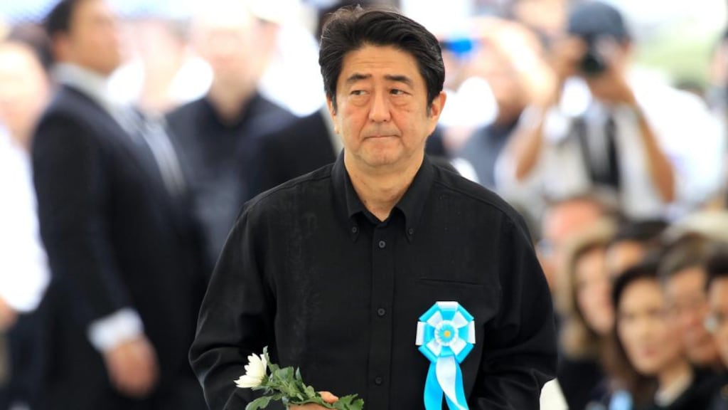 Japan’s prime minister Shinzo Abe walks towards a memorial to lay flowers for victims of the second World War Battle of Okinawa during a memorial service on Tuesday. Photograph: Hitoshi Maeshiro/EPA