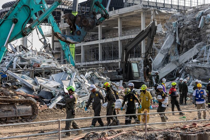 Thai rescue workers on Saturday remove a body that was recovered after a building collapsed in Bangkok's Chatuchak area. Photograph: Lauren DeCicca/Getty
