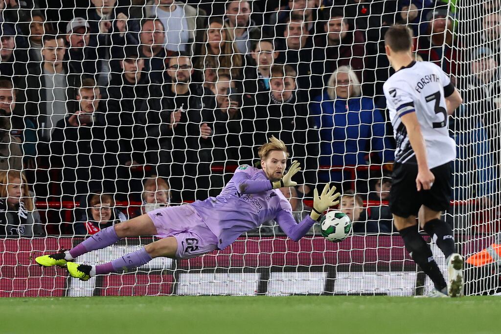 LIVERPOOL, ENGLAND - NOVEMBER 09: Caoimhin Kelleher of Liverpool saves a penalty taken by Craig Forsyth of Derby County during a penalty shoot out during the Carabao Cup Third Round match between Liverpool and Derby County at Anfield on November 09, 2022 in Liverpool, England. (Photo by Nathan Stirk/Getty Images)