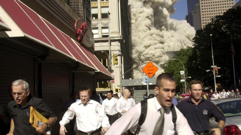 People run from the collapse of World Trade Center Tower on September 11th, 2001, in New York. Photograph: Suzanne Plunkett