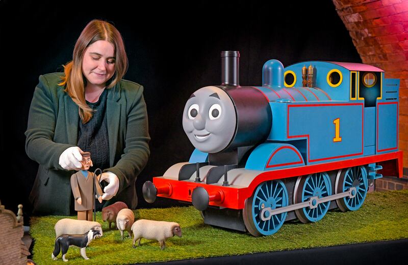Sian Taylor, the auction manager at Propstore, showcasing the original props from Thomas & Friends with signed items from celebrities including Olivia Colman, Eddie Redmayne and Hugh Bonneville. Photograph: Mattel/PA