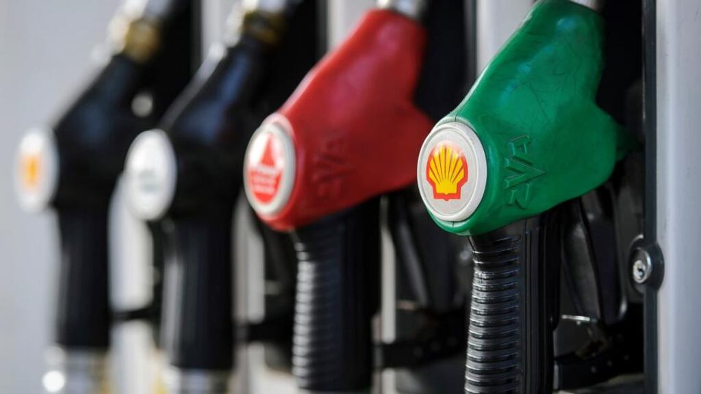 Fuel pump nozzles branded with the Shell logo sit at a gas station, operated by Royal Dutch Shell in Brussels. Photographer: Jock Fistick/Bloomberg