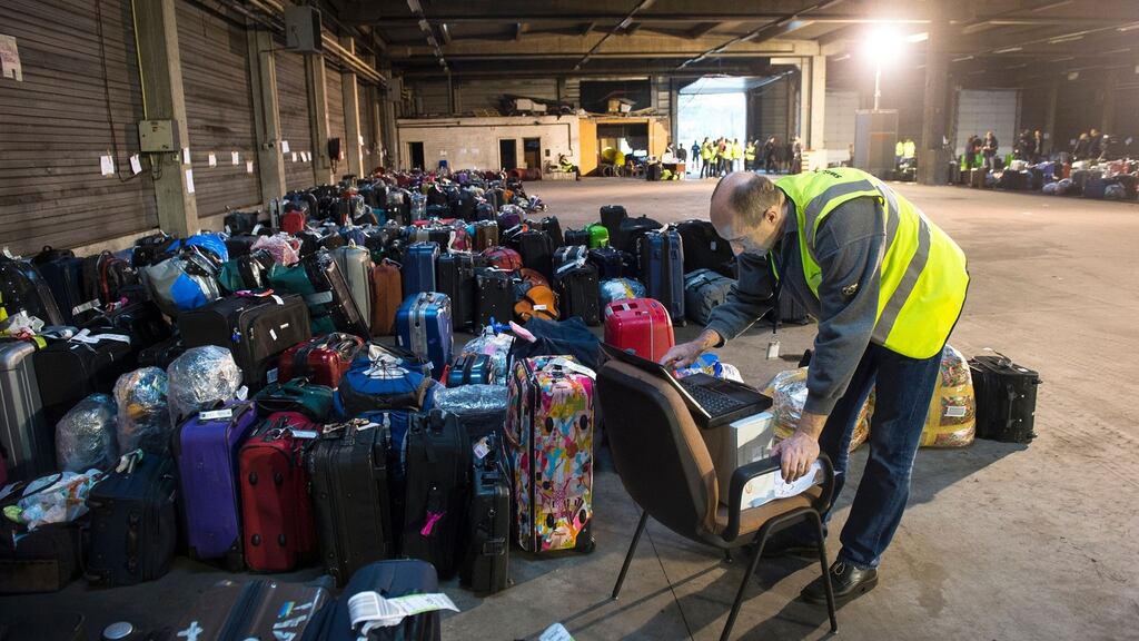 An agent looks on his computer near luggage collected from the planes, which were on the tarmac at the time of the attacks in Brussels. Photograph: Lauie Dieffembacq/ AFP /Belga/Getty