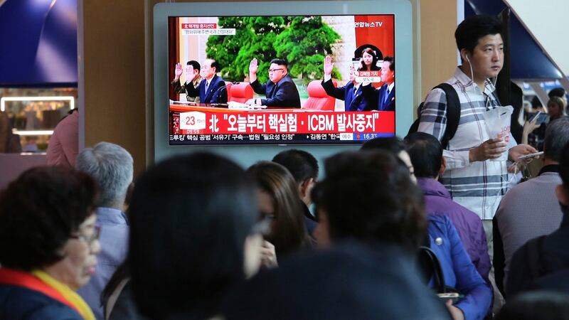 People watch a news programme in Seoul featuring North Korean leader Kim Jong Un announcing he had suspended nuclear and long-range missile tests. Photograph: Ahn Young-joon/AP