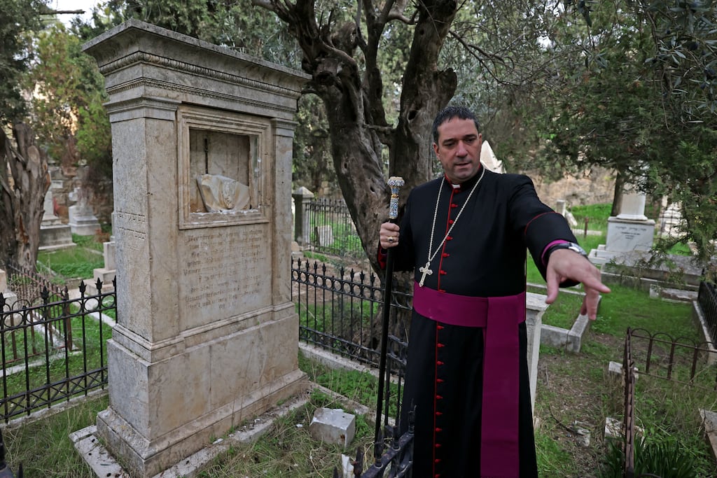 Archbishop Hosam Naoum inspects vandalised graves on Mount Zion outside Jerusalem's Old City in 2023. Photograph: Ahmad Gharabli/AFP via Getty Images
