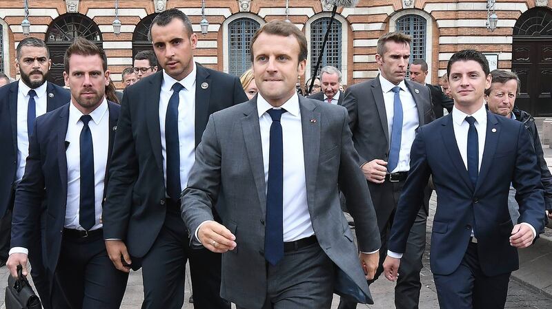 French president Emmanuel Macron, surrounded by members of the presidential security service, at the Place du Capitole in Toulouse, France. Photograph: Pascal Pavani/AFP/Getty Images