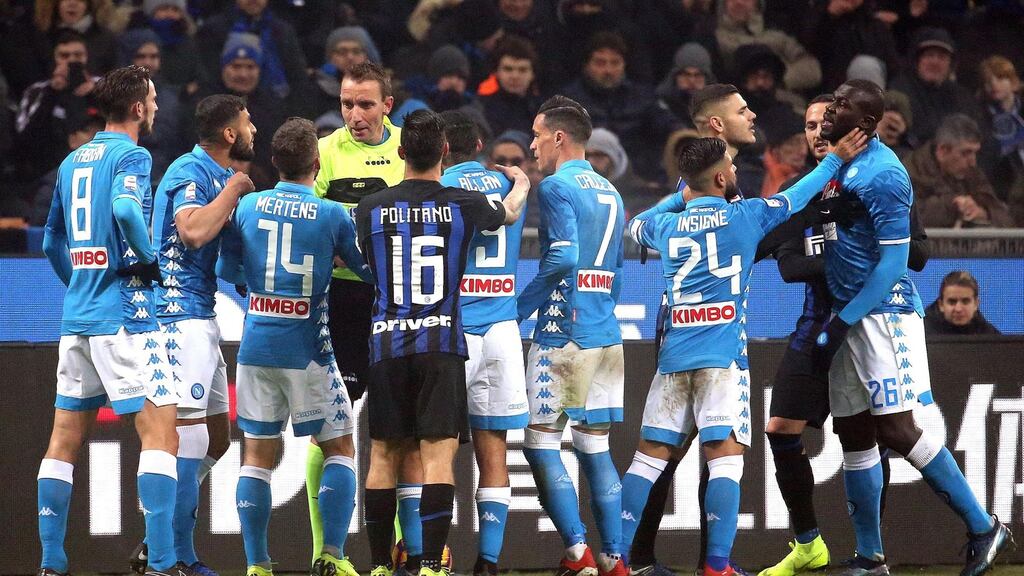 Napoli’s players argue with referee Paolo Mazzoleni at the San Siro. Photograph: EPA