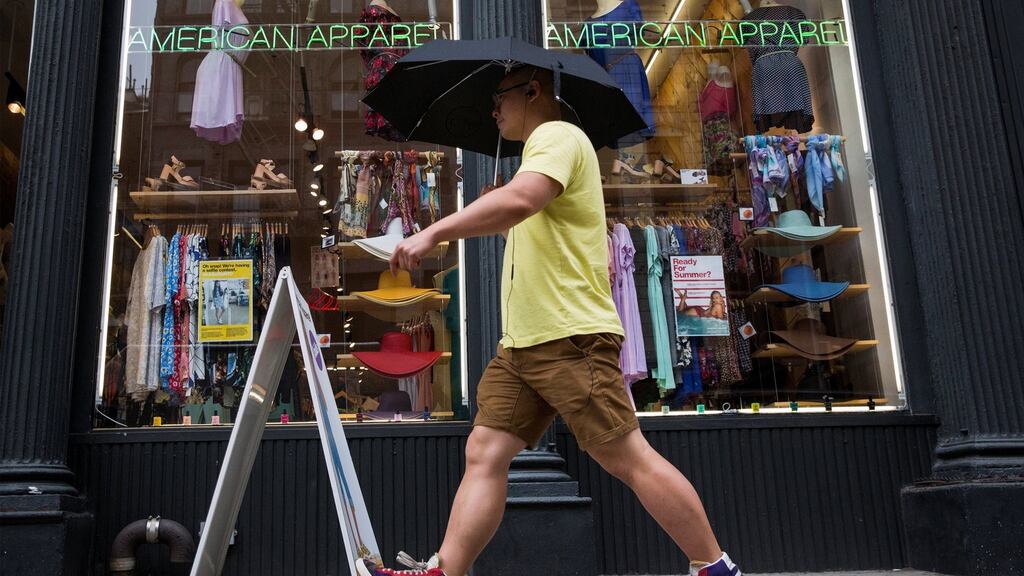A man walks past an American Apparel store in New York. Photograph: Brendan McDermid/File Photo/Reuters