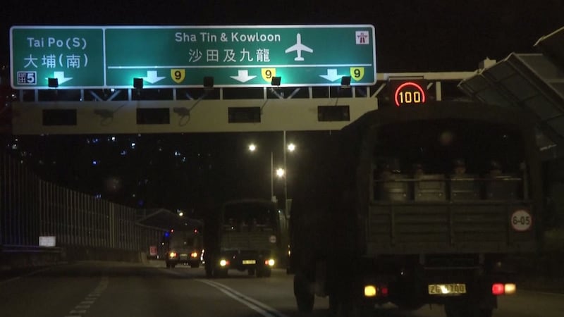 This screen grab taken from video released on August 29th from China’s state-run CCTV shows armoured personnel carriers and trucks carrying People’s Liberation Army (PLA) troops for the Hong Kong Garrison arriving in Hong Kong during a routine rotation of personnel. Source: AFP/Getty Images