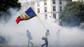 Police in Paris fire tear gas to repel protesters on May Day rally
