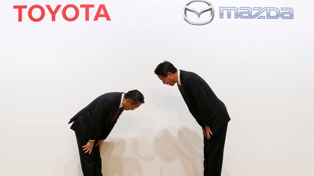 Toyota Motor President Akio Toyoda (L) and Mazda Motor Corporation President and CEO Masamichi Kogai (R) announcing their partnership. Photograph: Kim Kyung-Hoon/Reuters
