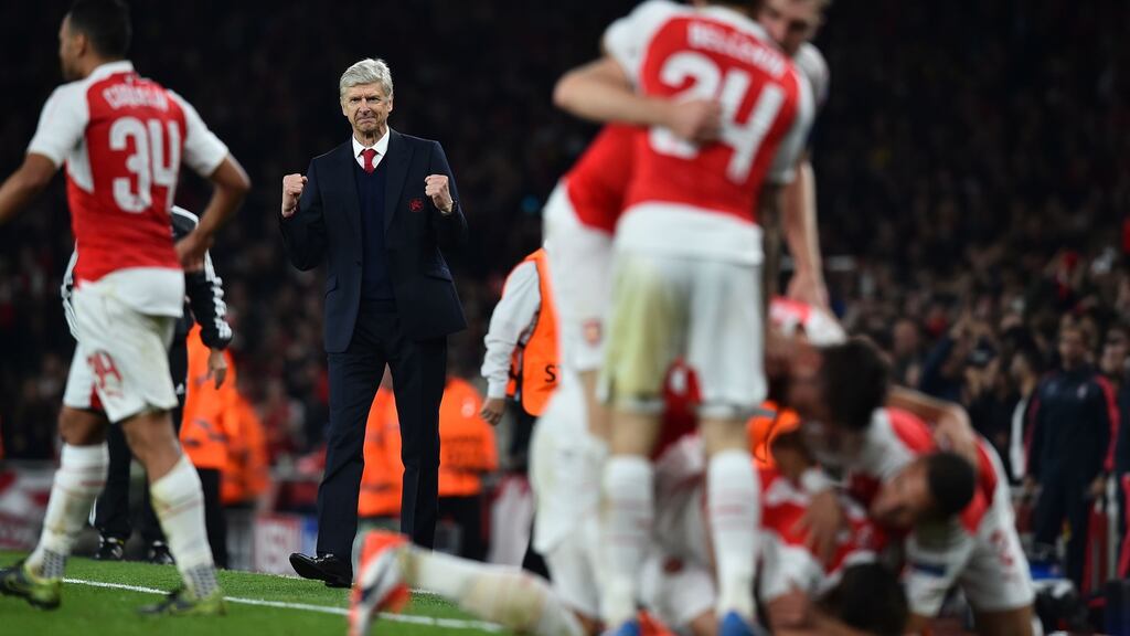 Arsenal manager Arsene Wenger reacts as his players celebrate Mesut Özil’s goal during the Champions League victory over Bayern Munich at the Emirates. Photograph: Ben Stansall/AFP/Getty Images