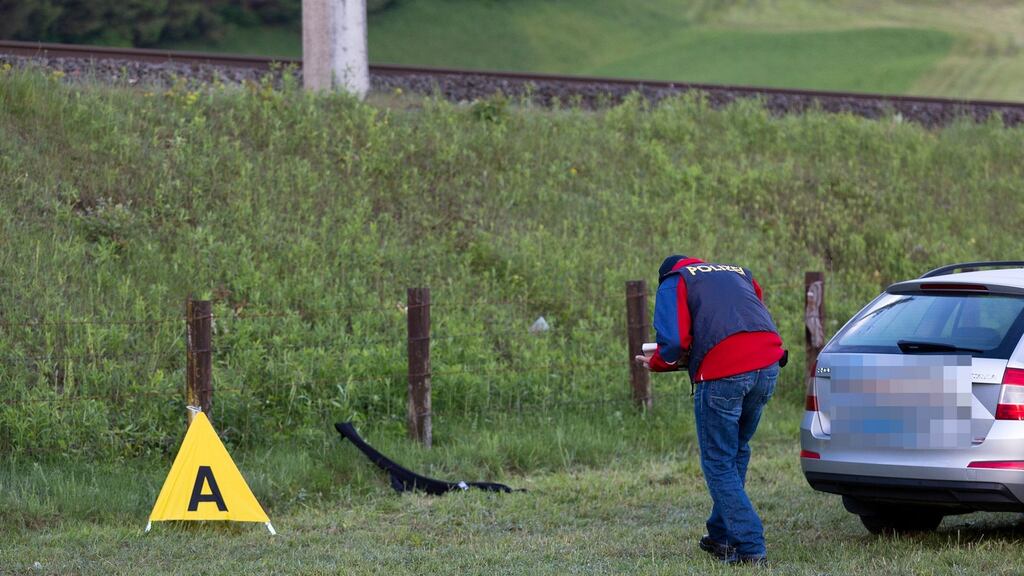 A police investigator taking evidence at the scene of a shooting in Nenzing, Austria, where a man fatally shot two people and wounded eleven before killing himself. Photograph: Dietmar Mathis/AFP/Getty Images