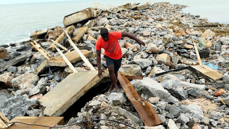 A man finds his way around a destroyed docking bay on the coast of Pemba city in the northeastern coast of Mozambique. Photograph: Tsvangirayi Mukwazhi/AP