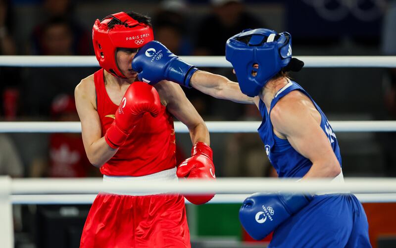 Ireland’s Kellie Harrington (blue) lands a punch against Yang Wenlu of China. Photograph: James Crombie/Inpho
