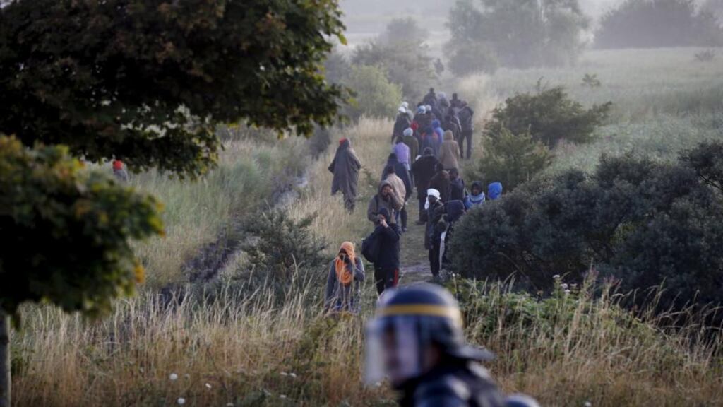 Migrants who were blocking the Eurotunnel ramp for trucks are pushed back by policemen at Coquelles near Calais. Photograph: Pascal Rossignol/Reuters