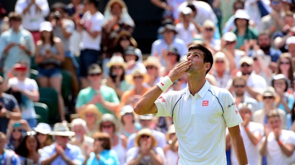 Novak Djokovic celebrates beating Jarkko Nieminen in their second-round match at Wimbledon. Photograph: Dominic Lipinski/PA