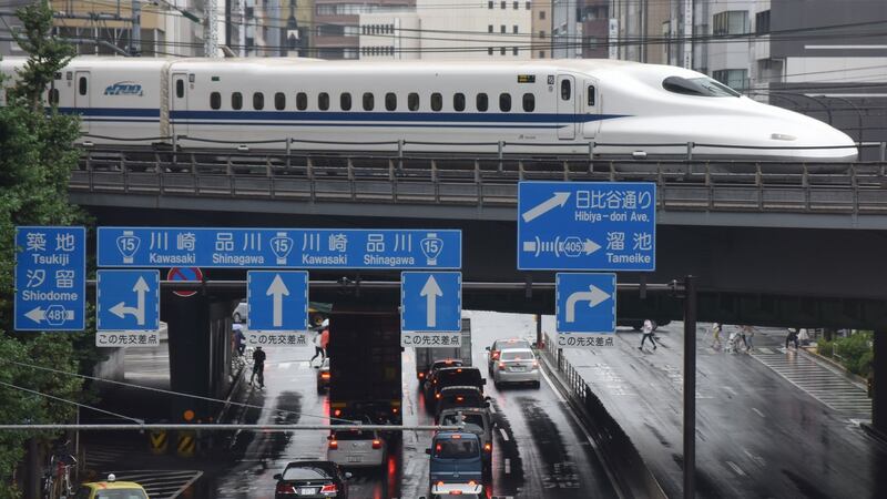 A bullet train moves above traffic in Tokyo. Photograph: Kazuhiro Nogi/AFP/Getty Images