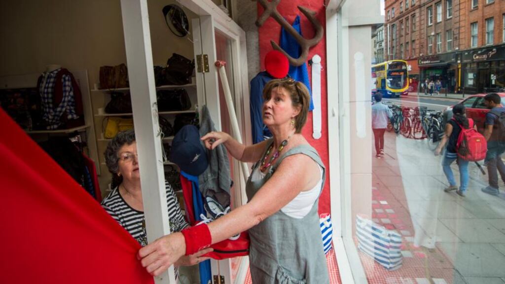 Anne Marie Keeley dresses the window in Enable Ireland’s outlet on South Great George’s Street, Dublin, with help from Clare Gilhooley (on left). Photograph: Dara Mac Dónaill