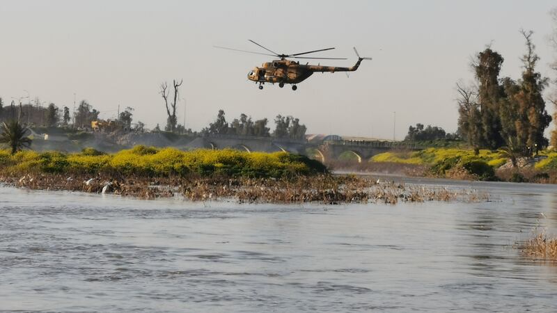 An Iraqi rescue helicopter searches for survivors at the site where an overloaded ferry sank in the Tigris river near Mosul in Iraq. Photograph: Reuters