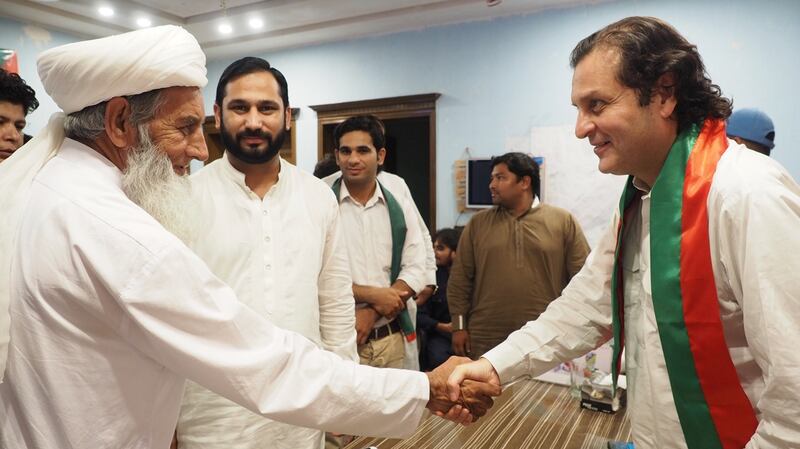Walid Iqbal (R), grandson of national poet Muhammad Iqbal and a candidate for Imran Khan’s Tehreek-e-Insaf party in the election in Pakistan, greets a local religious leader in Javed Colony, Lahore. Photograph: Lorraine Mallinder
