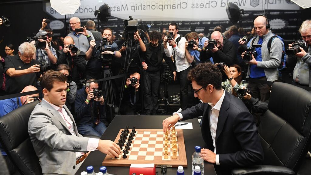 Norway’s World Chess Champion Magnus Carlsen (L) prepares to play against US challenger Fabiano Caruana (R) during round 12 of the World Chess Championships in London. Photo: EPA
