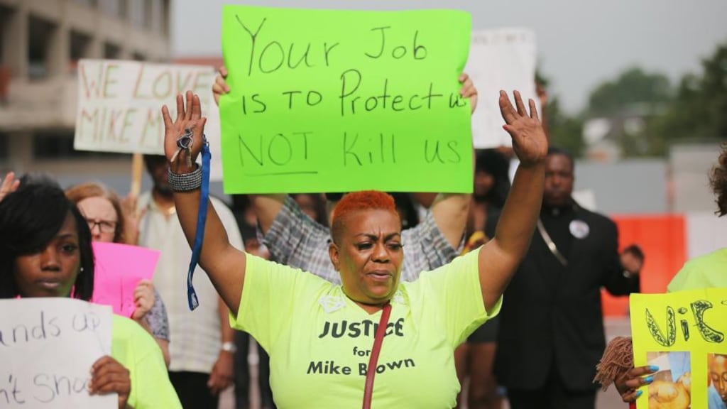 Demonstrators protest yesterday outside of the Buzz Westfall Justice Centre where a grand jury will begin looking at the circumstances surrounding the fatal police shooting of unarmed teenager Michael Brown by a Ferguson, Missouri, police officer on August 9th. Photograph: Scott Olson/Getty Images