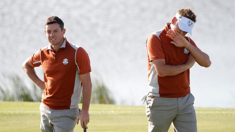Rory McIlroy and Ian Poulter during their foursomes match against Justin Thomas and Jordan Spieth. Photograph: Charles Platiau/Reuters