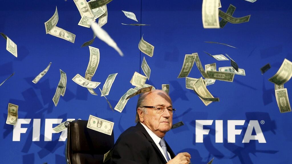 Former Fifa president Sepp Blatter is showered with fake banknotes at a press conference in 2015. Photograph: Arnd Wiegmann/Reuters
