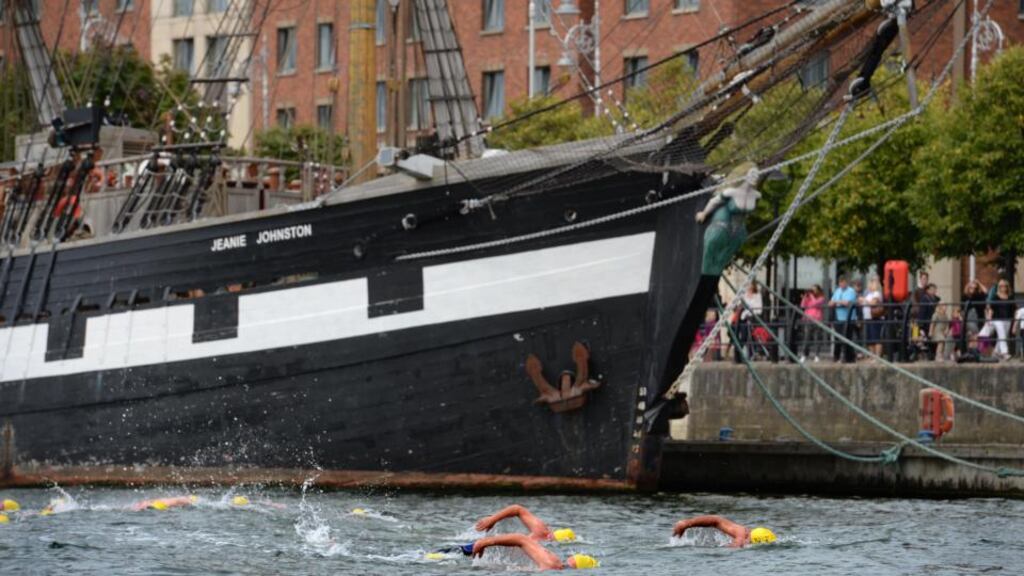 Passing the Jeanie Johnston during the 94th Liffey Swim – the ship was valued less than five months ago at €700,000, but costs €240,000 a year to run as a tourist attraction. Photograph: The Irish Times