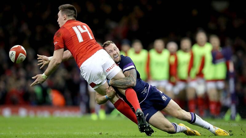 Wales’s Josh Adams is tackled by Byron McGuigan of Scotland. Photograph: Ryan Byrne/Inpho