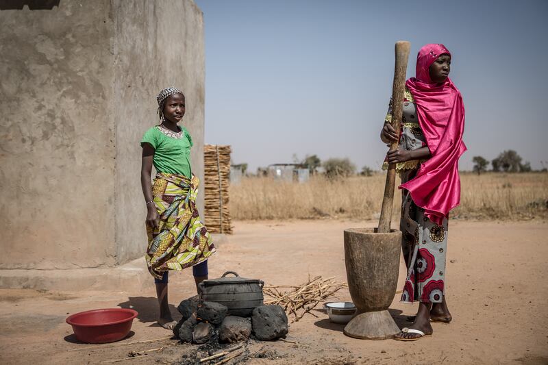 Pounding millet in a refugee camp, or so-called 'village of opportunity', in southern Niger. Photograph: Sally Hayden