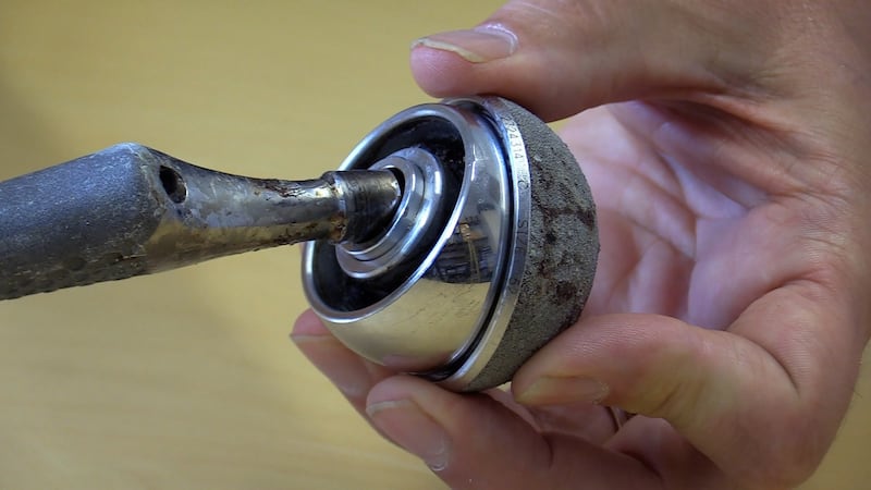 Prof David Taylor, Trinity College Dublin, holds the metal-on-metal ball and socket elements of the controversial DePuy ASR replacement hip system. Photograph: Bryan O’Brien / The Irish Times