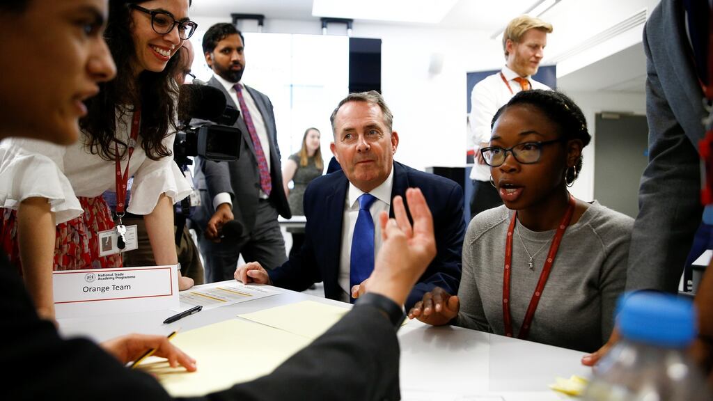 Britain’s Secretary of State for International Trade Liam Fox visits students taking part in a mock trade negotiation. Photograph: Reuters