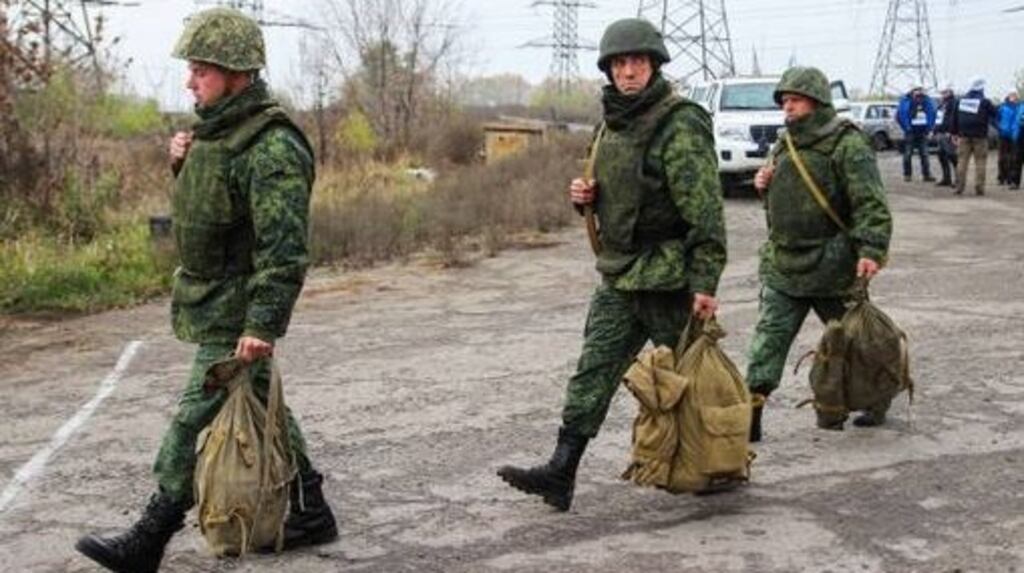 Members of the Luhansk People’s Republic leaving a disengagement area near the town of Zolote in the Luhansk region. Photograph: Alexander Reka\TASS via Getty Images