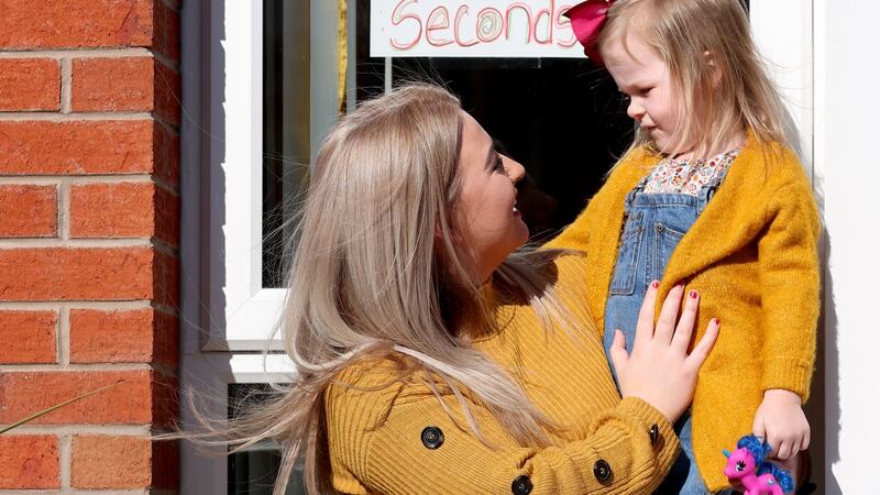 Cliodhna Tolan and her daughter Zaira, who entered a drawing competition to brighten up their neighbourhood in the Upper Springfield area of Belfast. Photograph: Stephen Davison