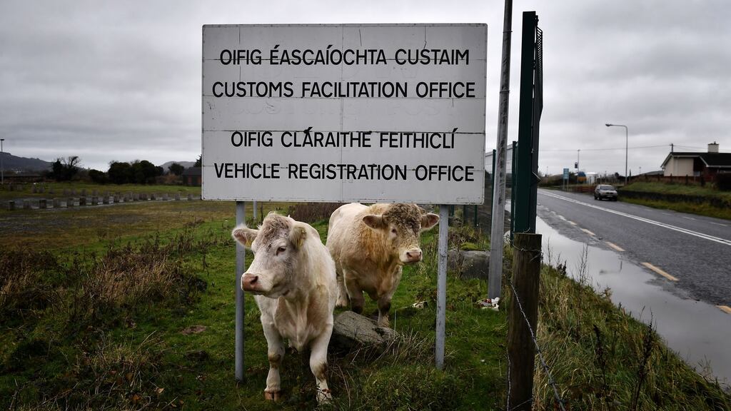 Cows stand beneath a sign for the diused Customs Office along the Irish Border   in Newry, Northern Ireland. Photograph:  Charles McQuillan/Getty Images