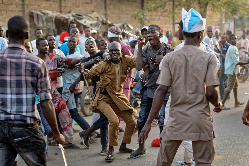 Supporters of the ruling party and main opposition party briefly pull knives and machetes on each other during an otherwise celebratory gathering of supporters of president Muhammadu Buhari anticipating victory, in Kano, northern Nigeria on Monday. Photograph: Ben Curtis/AP