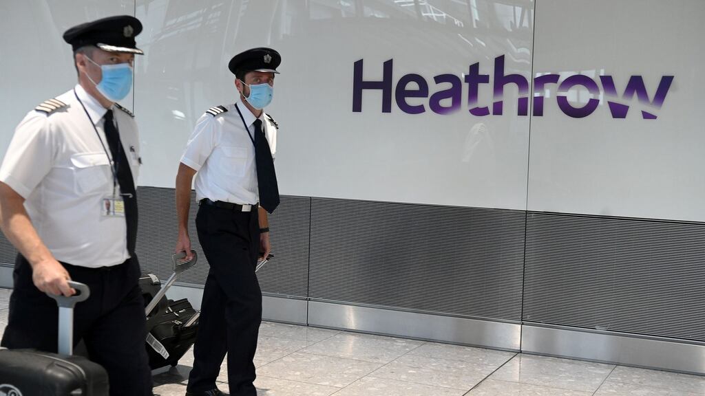Air crew wearing a face masks arrive at Heathrow airport, west London. Photograph: Daniel Leal-Olivas/AFP via Getty Images)
