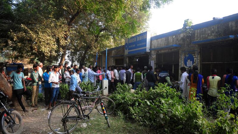 Indian villagers queue to deposit and exchange 500 and 1,000 rupee notes at a bank in Gohari village on the outskirts of Allahabad. Photograph: Sanjay Kanojia/AFP/Getty Images