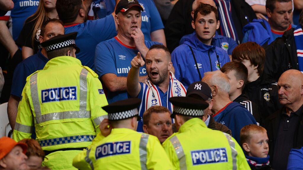 Police officers and stewards go into the Linfield supporters section as tempers flare during the Uefa Champions League clash against Celtic. Photo: Mark Runnacles/Getty Images