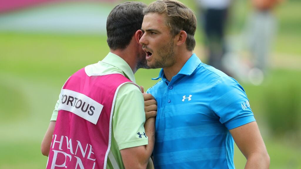 Haydn Porteous of South Africa with his caddie after finishing his round on at the Tshwane Open at Pretoria Country Club. Photograph: Getty Images