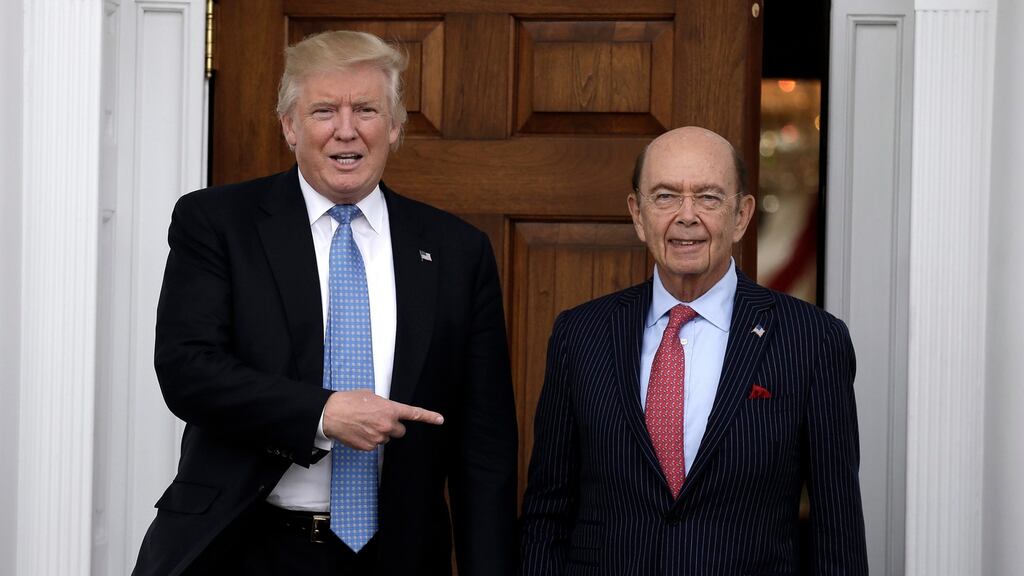 US president-elect Donald Trump  points to investor Wilbur Ross at  Trump International Golf Club in  New Jersey on Sunday. Photograph: Peter Foley/EPA