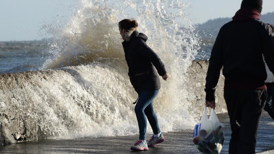 Dodging the waves at high tide on Sandymount’s coast road today. Photograph: Cyril Byrne/The Irish Times