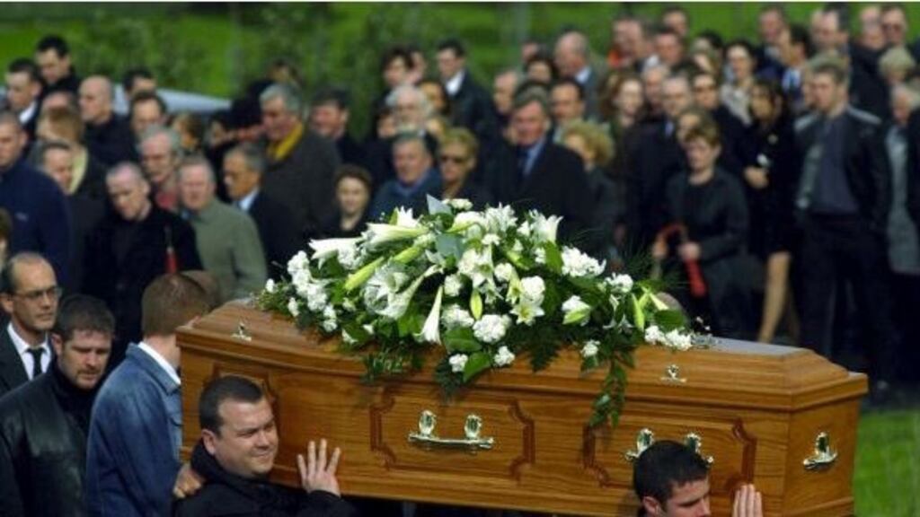 The remains of Sunday World journalist Martin O’Hagan being taken from his home in Lurgan, Co Armagh, in 2001. Photograph: Bryan O’Brien