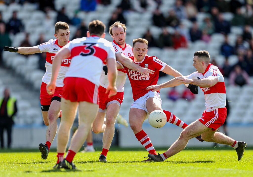 Cork’s Steven Sherlock shoots on goal despite being surrounded by Derry players at Páirc Uí Chaoimh on Sunday. Photograph: Ken Sutton/Inpho