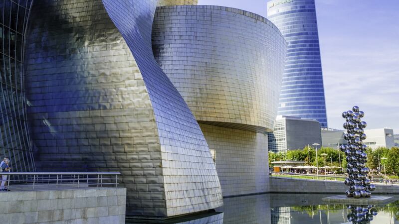 The Guggenheim Museum in Bilbao, a titanium-clad, iron-girded structure designed by Frank Gehry